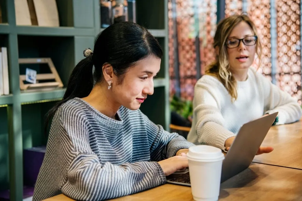 Designers collaborating on a UI project at a laptop